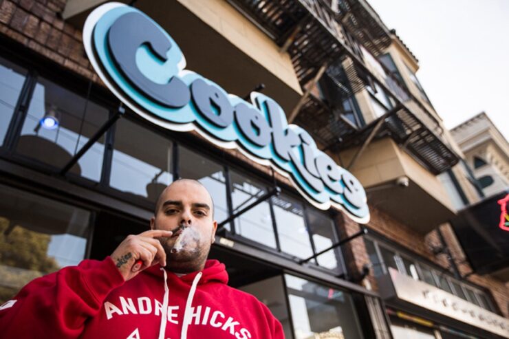 Berner standing in front of outlet of his brand named "Cookies"